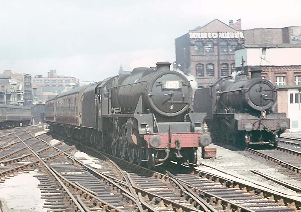 British Railways built 5MT 4-6-0 No 44691 enters the station at the head of an up express service on 9th June 1965