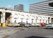View of the main booking hall and forecourt deprived of its roof now used as a carpark on 2nd March 1972