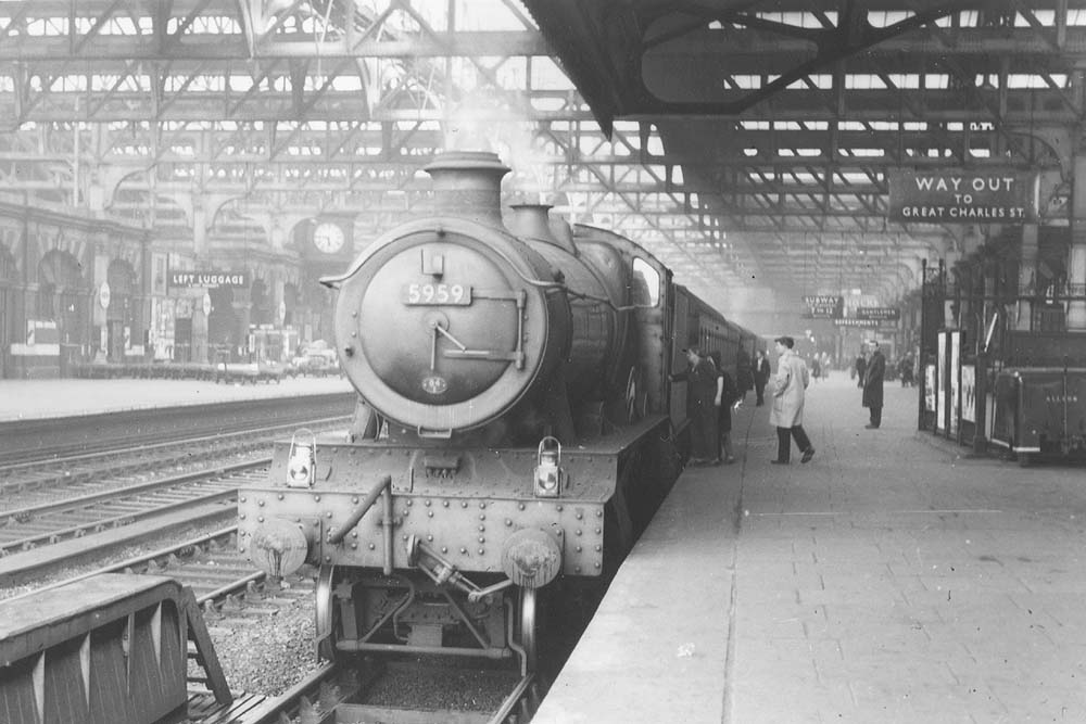 Ex-GWR 4-6-0 Hall class No 5959 'Mawley Hall' is seen standing at Platform 5 whilst at the head of a down semi-fast express service