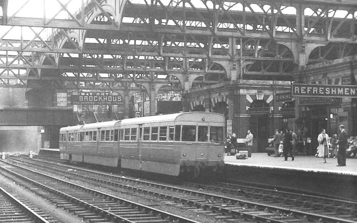 A three-car, four wheel ACV Lightweight Diesel Unit standing at Snow Hill station's Platform 5 with a local service