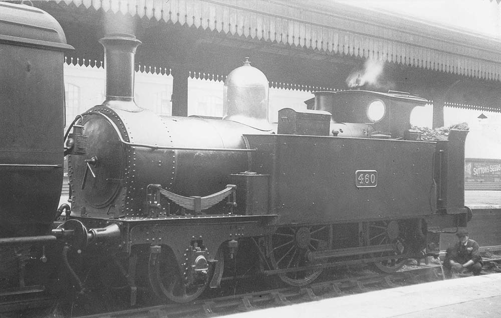 GWR 2-4-0T 'Metro Tank' No 460 is seen in half-cab form whilst whilst simmering and standing at Platform 3 at the head of a local passenger train