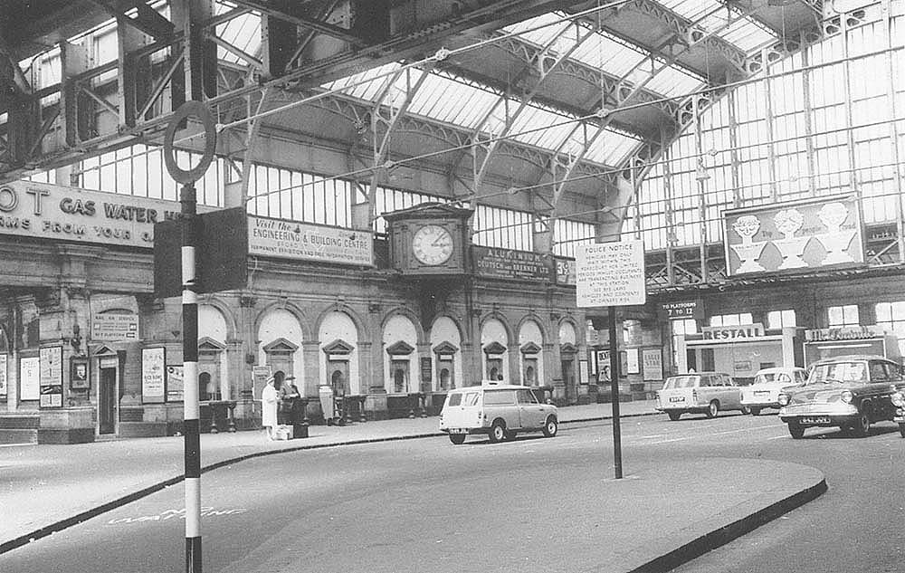 A 1960s view of the Concourse showing advertising hoardings around the bottom of the glass roof and car parking bays in the driveway area