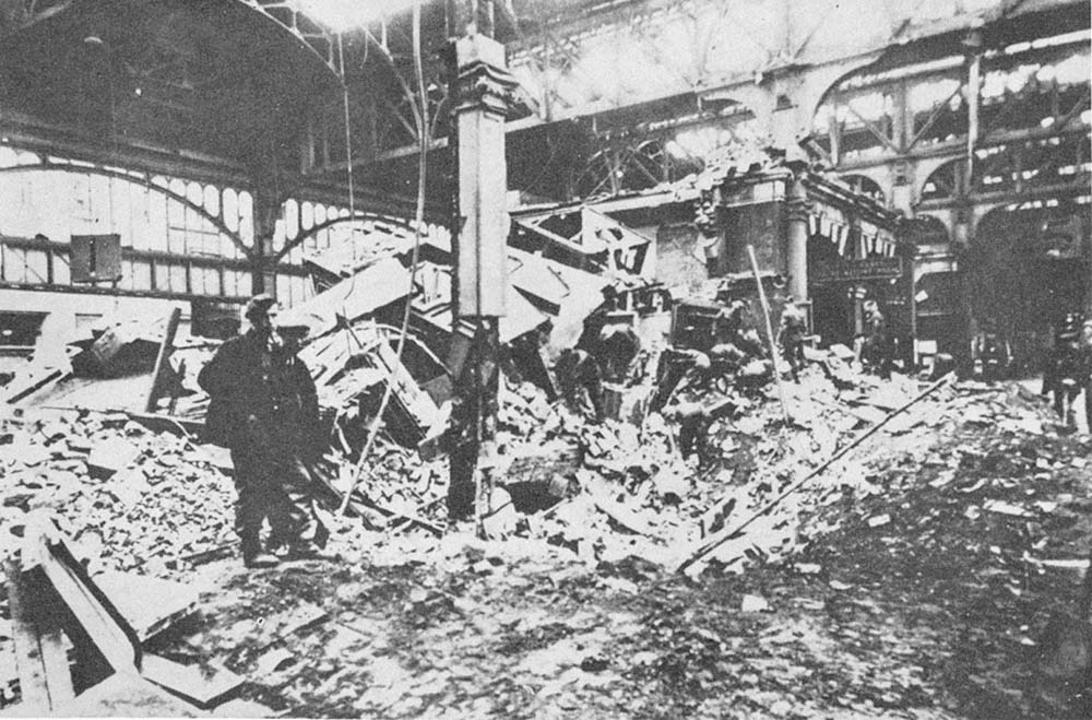 A workman stands amongst the debris on Platform 5 on the morning of the 10th April 1941 following the largest air raid suffered by Birmingham