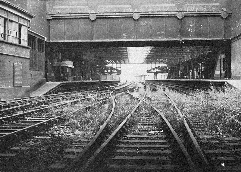 View of the near derelict station looking along the main through roads of Snow Hill station towards Wolverhampton with weeds growing through the tracks