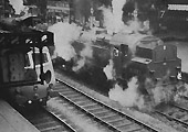 British Railways 2-6-4T Standard Class 4 No 80072 is seen with an unidentified ex-GWR Manor class locomotive standing on the down through line in the 1960s