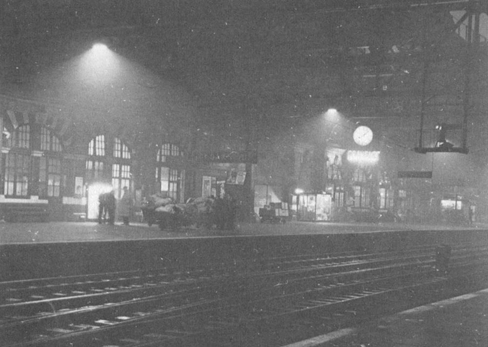 A 1950 night view of Platform 7 after the crowds have gone whilst station staff prepare the mail bags for forwarding by the next postal service