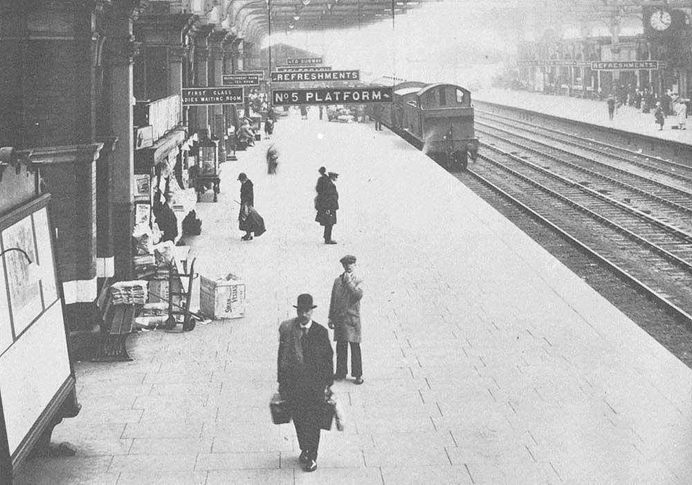 Looking from the steps of the overbridge towards Wolverhampron along Platform 5 whilst a train is seen standing at the platform