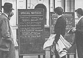 Passengers look at the Special Notice advertising emergency services being operated during the rail strike in on 30th May 1955