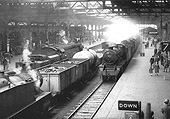 Ex-SR 4-6-2 West Country Class No 34094 is seen standing on the down through road whilst ex-LMS 2-8-0 8F No 48417 stands on Platform 7 on 27th April 1963