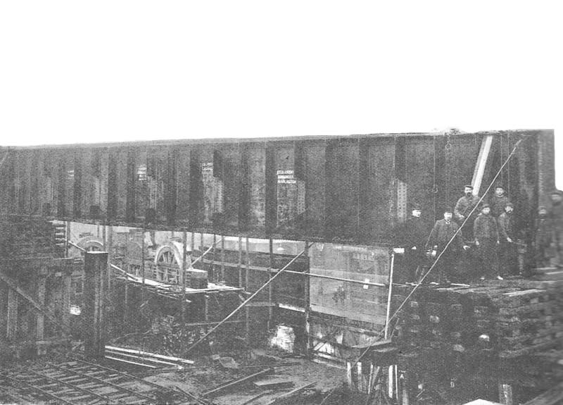The first of the main girders being lowered on to their supporting columns by the progressive removal of the sleepers