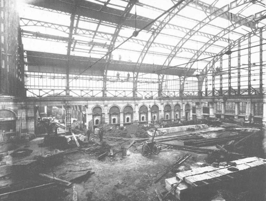 The vast new booking hall under construction in 1911 with the walls and ornate porticos for the ticket issuing windows