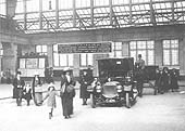 Close up showing the East side of Snow Hill station's Concourse with a chauffeured driven car and horse-drawn carriage in view