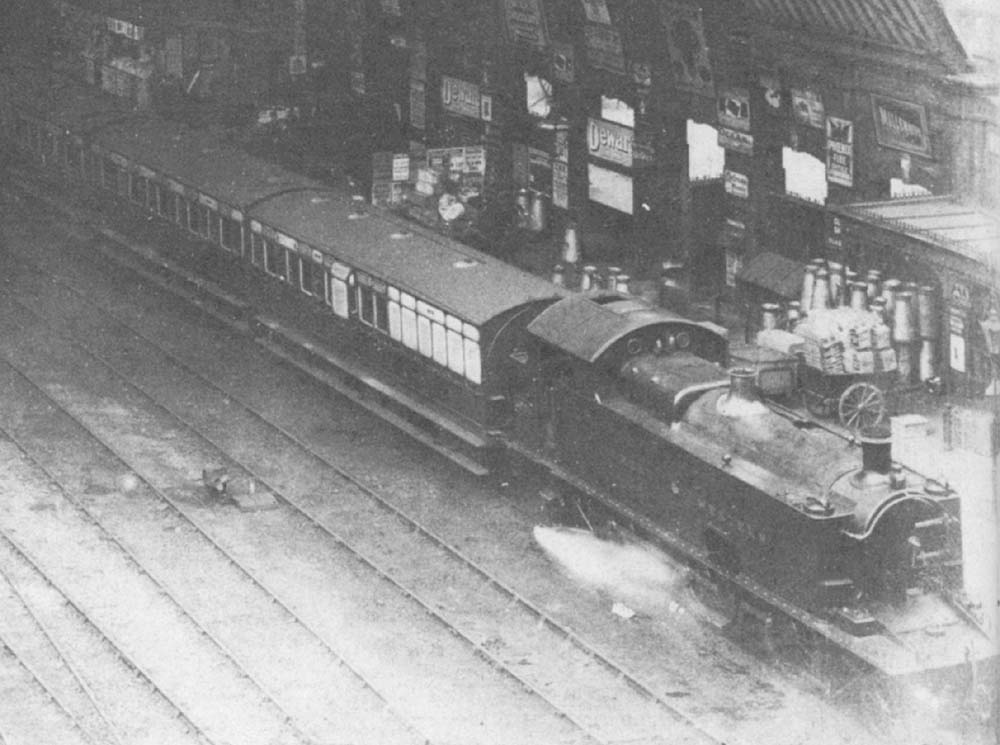 Close up of an unidentified GWR 39xx class 2-6-2T locomotive, one of a class of twenty converted from 0-6-0 Dean Goods engines, standing at the head of an up local passenger train