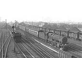 An unidentified ex-GWR 4-6-0 Hall class locomotive is seen on up express parcels service as it passes through the station 