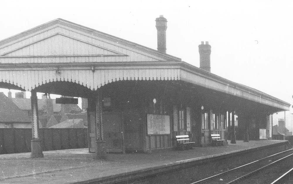 Close up showing the relief down and up platforms and the two island passenger buildings with the steps to the road at the far end of the platforms