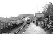 Claverdon station as a train steams under the road bridge at the Bearley end of the station