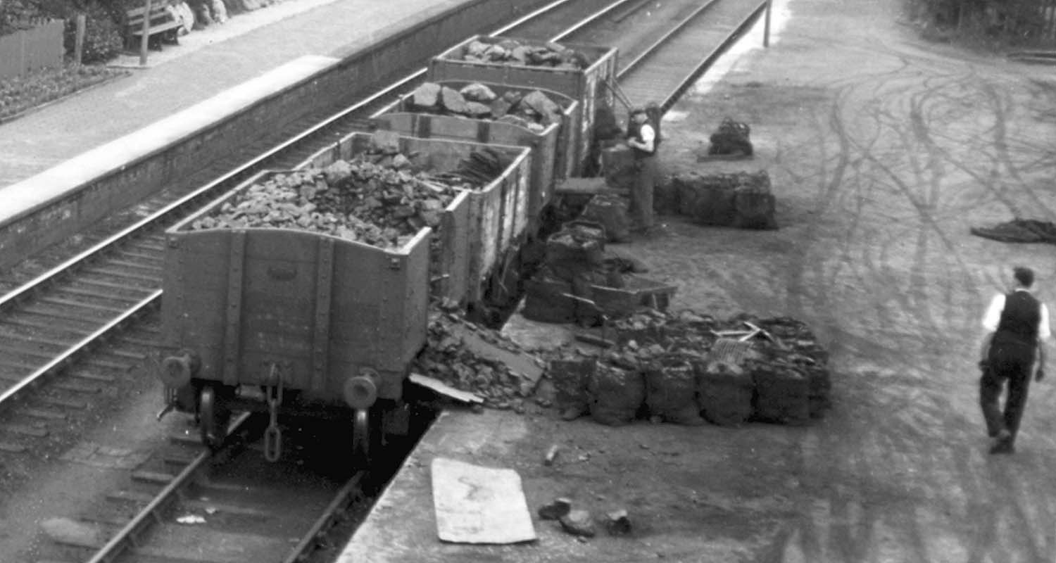 View of loading bank showing two open wagons with rounded ends, a common feature in early open wagons