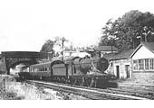 GWR Collett 0-6-0 2251 class No 3217 on a two coach train passes under the road bridge after leaving Claverdon station