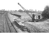 View of the widening works with a contractors narrow gauge tramway being loaded by a crawler crane and bucket