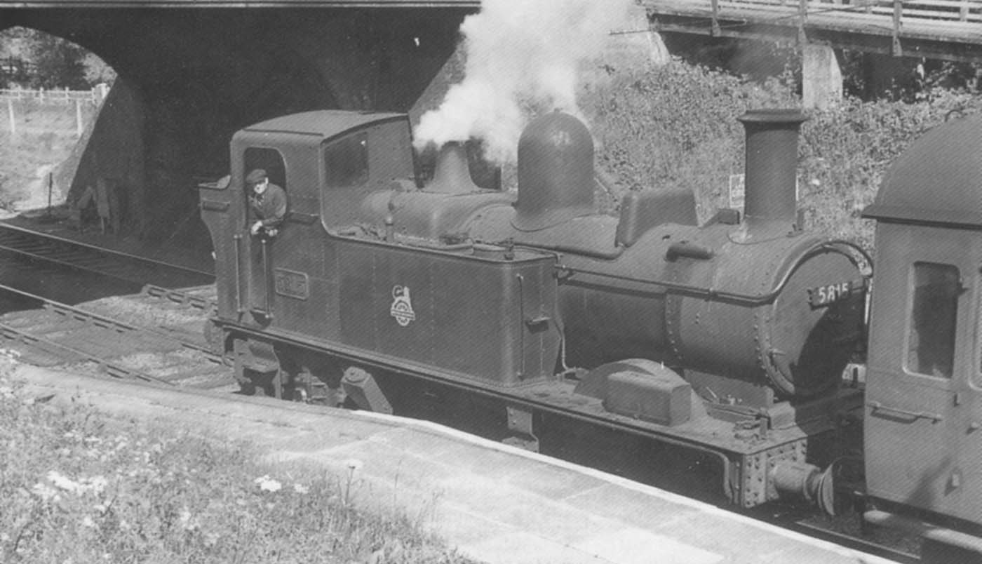 Ex-Great Western Railway 0-4-2T 58xx Class No 5815 pauses to run bunker first on a local stopping service to Leamington