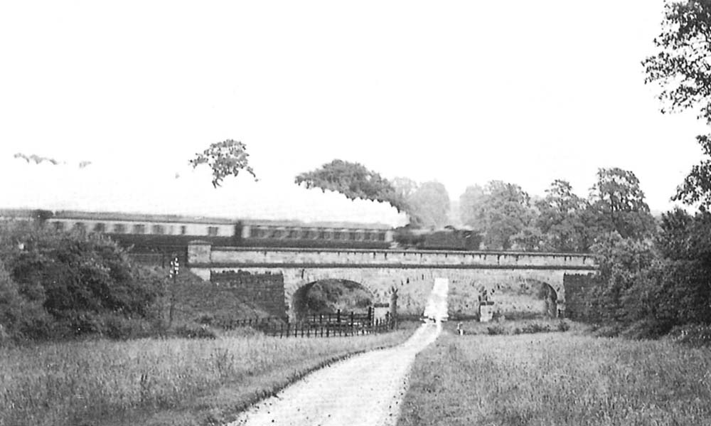 An unidentified ex-GWR 2-6-2T Prairie tank engine is seen running bunker first over the three elliptical arch bridge which carried the line over the drive to Umberslade Hall