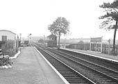 Looking towards Birmingham from beneath the passenger footbridge with a British Railways DMU stop sign seen adjacent to the platform lock up