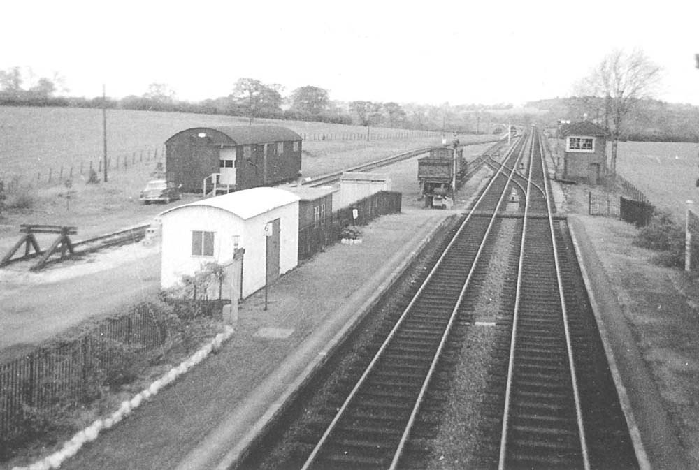 An elevated view from the passenger footbridge looking  towards Birmingham and showing the goods yard on the left and the signal box on the right