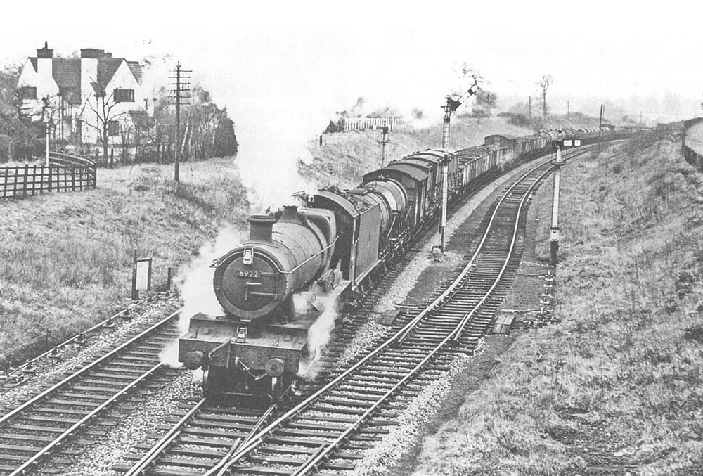 Ex-GWR 4-6-0 No 6922 'Burton Hall' passes the down refuge siding and the  raised upper quadrant signal in early 1965