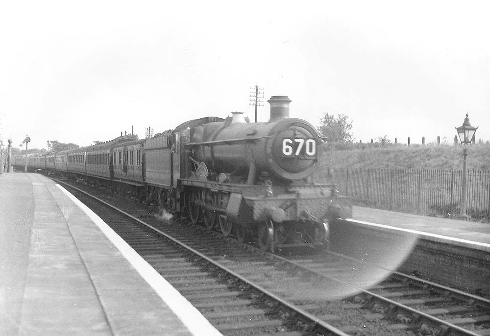 GWR 4-6-0 Hall class No 5938 'Stanley Hall' is seen passing through Earlswood station at the head of an up West Country express service