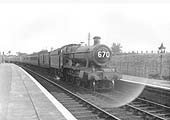 GWR 4-6-0 No 5938 'Stanley Hall' passes through the station at the head of an up West Country express service