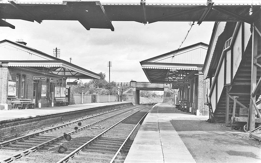 Looking towards Birmingham from under the passenger footbridge and along the down platform with Rumbush Lane road bridge marking the station's boundary