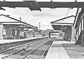 Looking towards Birmingham from under the passenger footbridge and along the down platform with Rumbush Lane road bridge marking the station's boundary