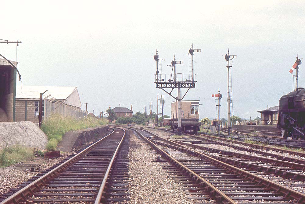 Looking along the former SMJ lines to Stratford upon Avon with a freight service waiting on the right in the down passing loop line on 23rd June 1966