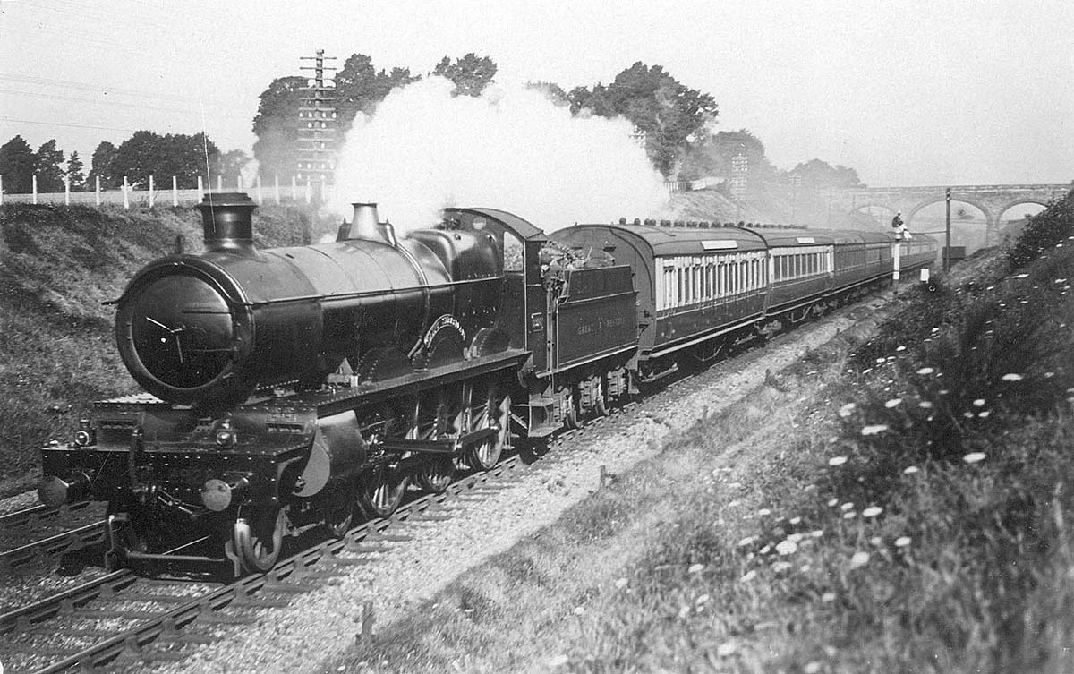 An unknown GWR 4-6-0 'Saint' class locomotive is seen passing near Fenny Compton during the 1920s