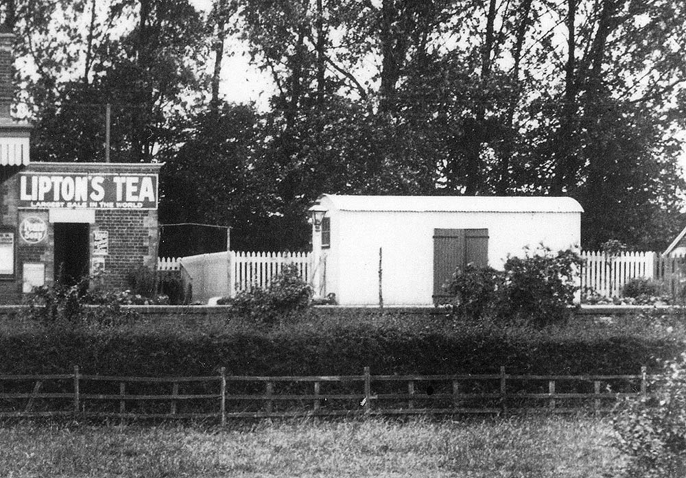 Close up showing the gentlemen's toilet and steel corrugated goods shed situated on the platform