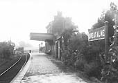 Looking along Great Alne's single line platform towards the level crossing and Alcester Town