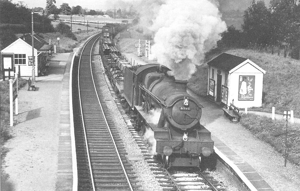 British Railways built 4-6-0 No 6995 'Benthall Hall' passes through Grimes Hill & Wythall Platform with a southbound mixed freight in 1964