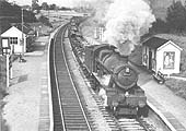 BR built 4-6-0 No 6995 'Benthall Hall' passes through Grimes Hill & Wythall Platform with a southbound freight