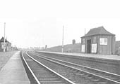 Looking towards Birmingham in the late 1930s with a train in the distance about to arrive at the up platform on the right