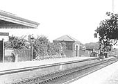 Close up showing the up platform showing the goods lock up shed behind the shubbery and the permanent way workers mess hut and store