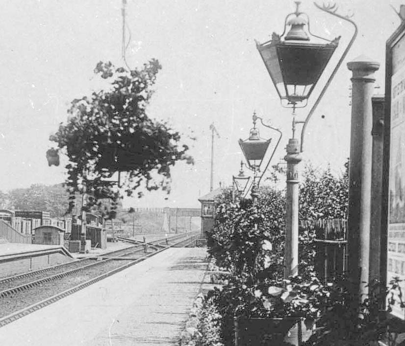 Close up showing the down platform with the signal box at the end of the platform and the lamps blackened for wartime precautions
