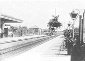 Looking towards Birmingham with the goods yard and a row of wagons seen in the distance at the end of the up platform on the left