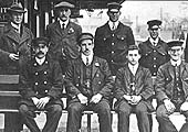 View of Hall Green's station staff, including porters and signalmen, seated on the Birmingham platform whilst posing for the camera