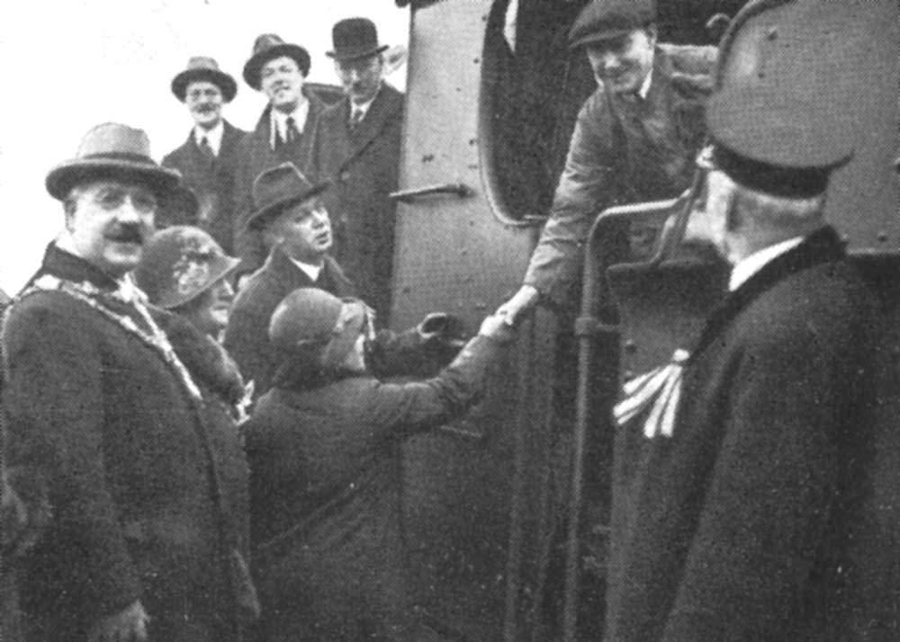 The Mayors, aldermen and civic officers and directors the two teams shake hands with the driver of the train