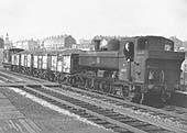 Ex-GWR 57xx class 0-6-0PT No 8767 is seen running bunker first whilst at the head of a four wagon local coal service in March 1966