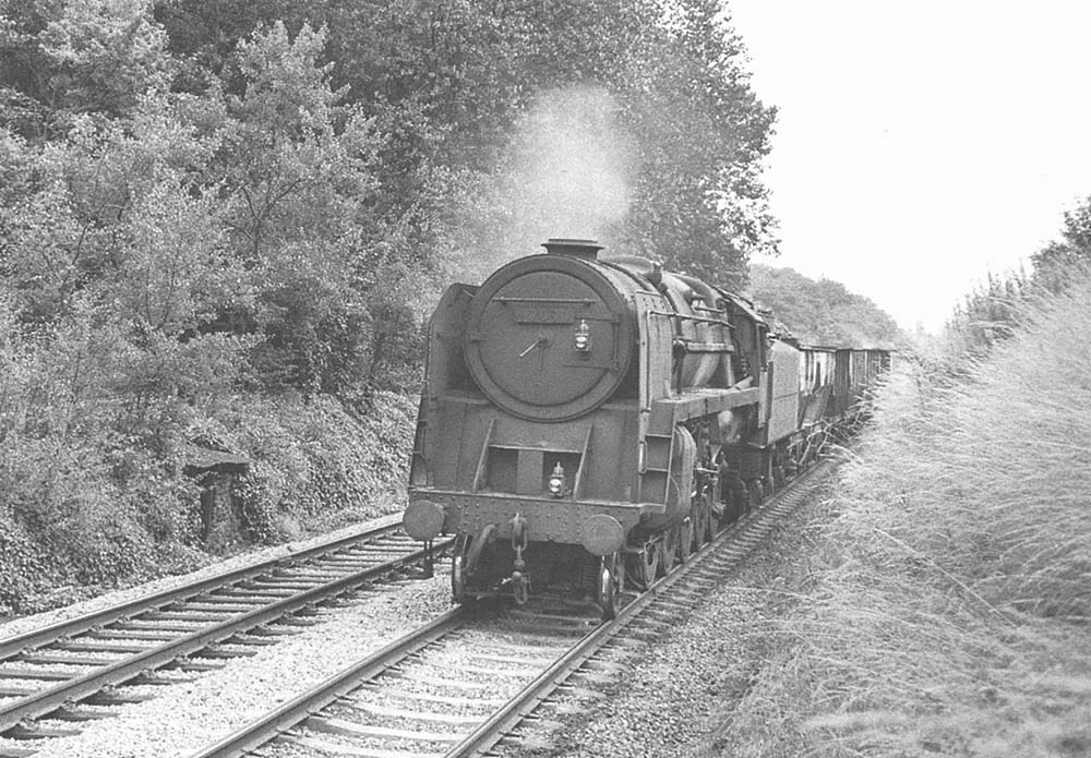British Railways Standard Class 9F 2-10-0 No 92090 approaches the southern end of Harbury tunnel on a down mineral train on 18th July 1966