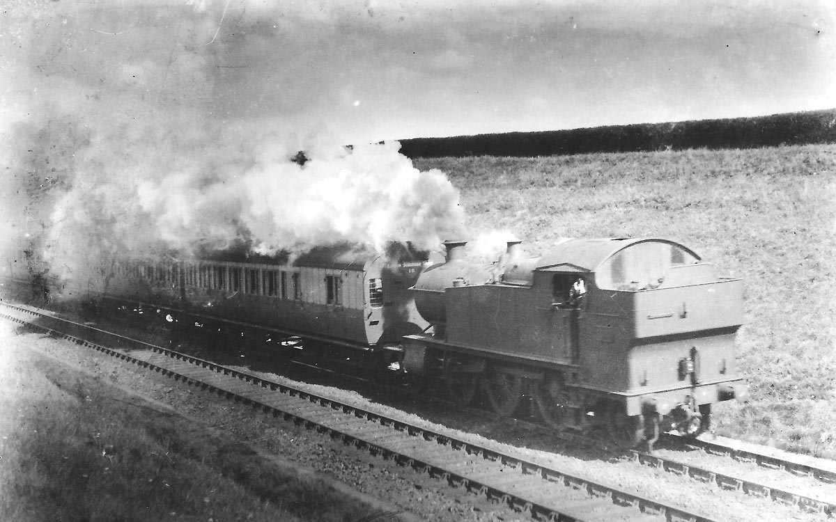 An unidentified Great Western Railway 2-6-2T 31xx class prairie tank locomotive running bunker first with an up suburban passenger service from Leamington Spa in Whitnash Cutting