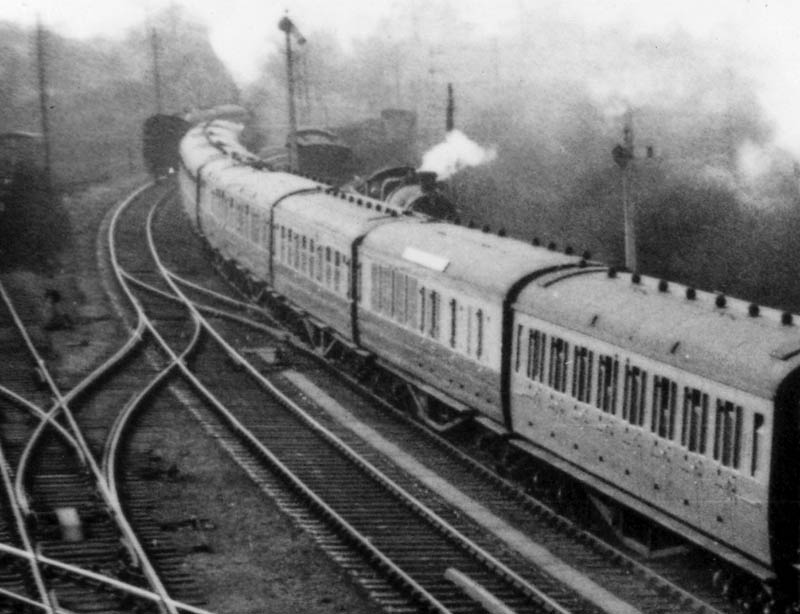 Close up behind the up Cambrian Coast Express with on the left a train attacking the climb up Hatton Bank and a goods train standing on a refuge siding