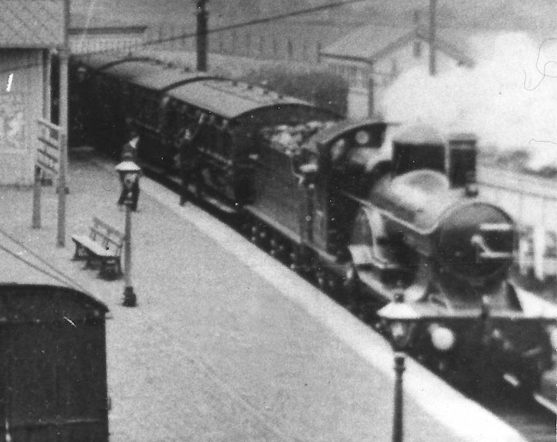 Close up showing an unidentified GWR 3031 (Achilles) class 4-2-2 locomotive at the head of the waiting Stratford-upon-Avon train