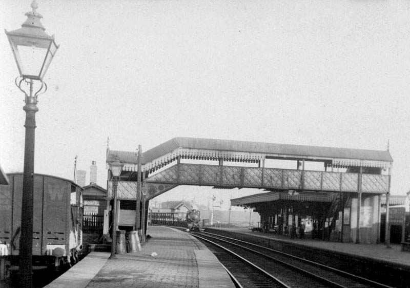 Close up showing an unknown GWR 0-6-0 goods locomotive leaving the down refuge siding at the head of a long cattle train
